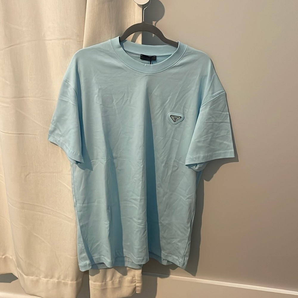 Prada Men's Light Blue Tee. Size: XL. Never worn, perfect condition.
